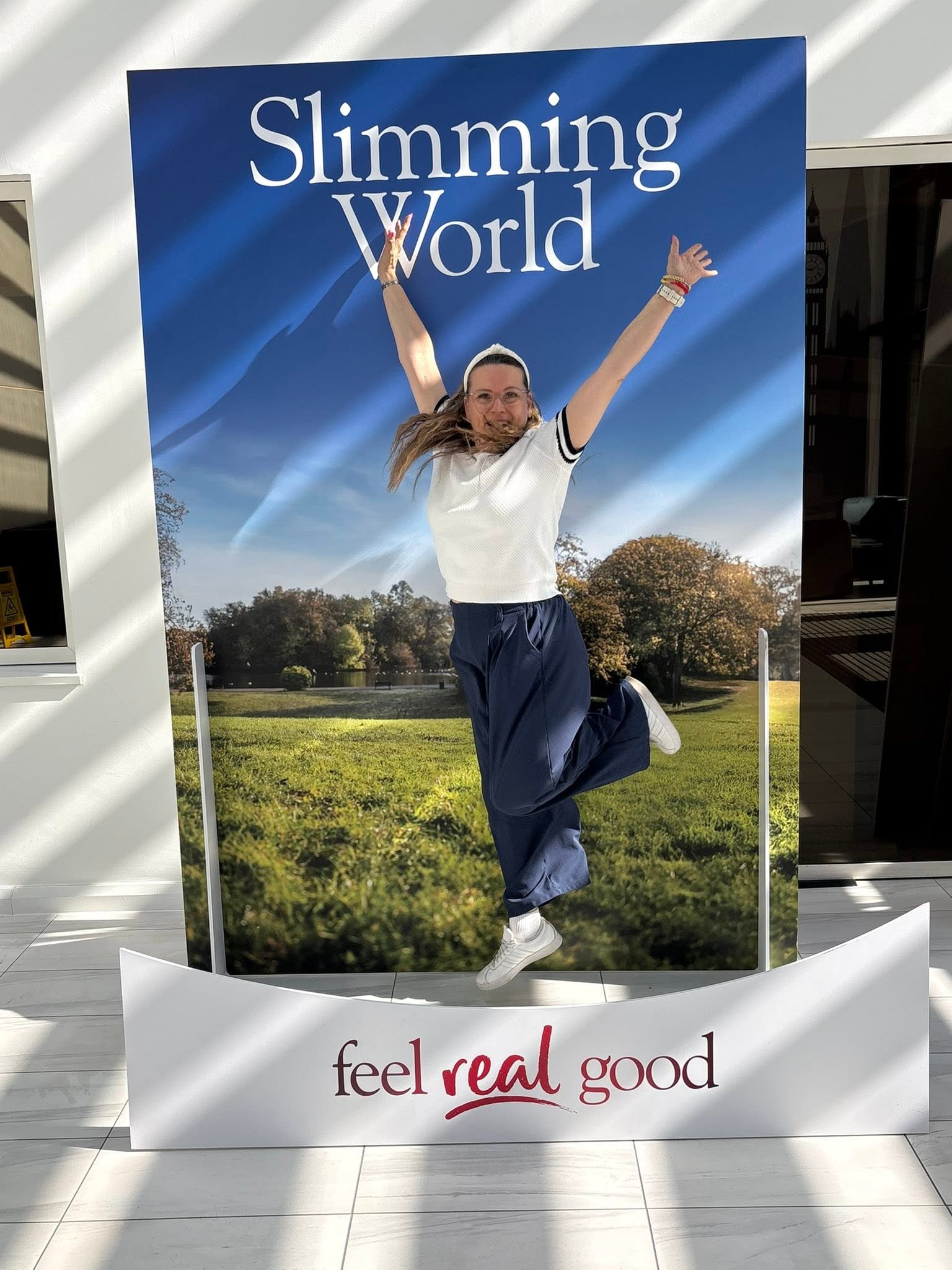 Celebrating weight loss success with arms raised